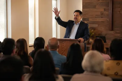 Latino Pastor Preaching in Church Hall