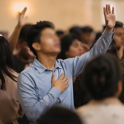 Raised Hands in Indoor Worship Gathering