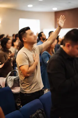 Latino Congregation Worshipping in Blue Chairs