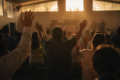 Raised Hands in Community Worship Hall
