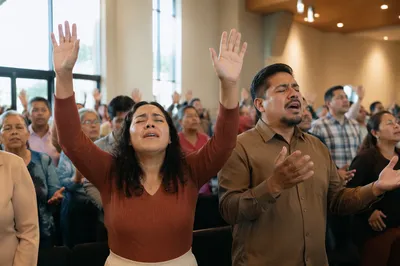 Latino Congregation with Hands Raised in Worship