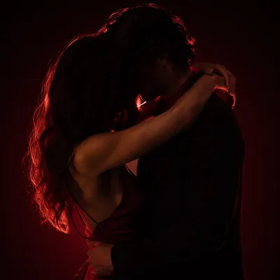 Romantic Couple Embracing in Warm Crimson Silhouette