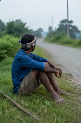 Reflective Man Resting by Rural Road