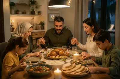 Middle Eastern Family Praying at Dinner Table