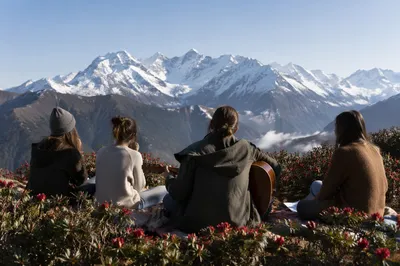 Young Adults with Guitar on Mountain Hillside