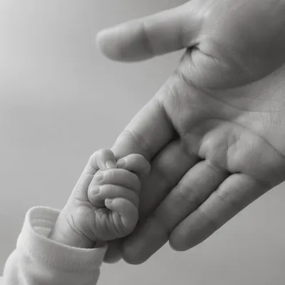 Tender Newborn Hand in Mother’s Palm