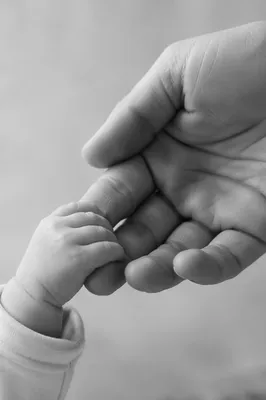 Tender Mother and Newborn Hand Bond