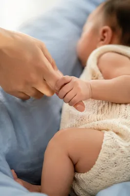 Tender Newborn Hand Holding Mother’s Finger