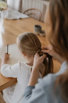 Tender Mother Braiding Childs Hair