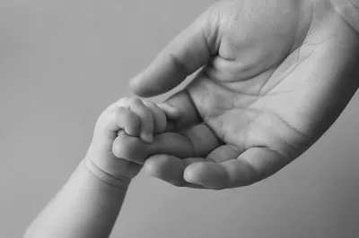 Tender Mother and Newborn Hands Bonding