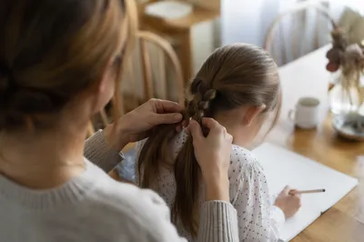 Tender Mother Braiding Child’s Hair