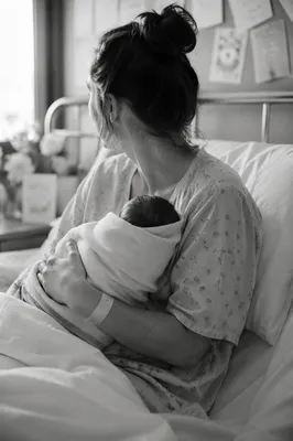 New Mother Cradling Newborn in Hospital