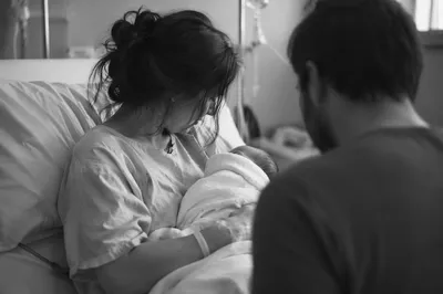 Tender Mother Holding Newborn in Hospital