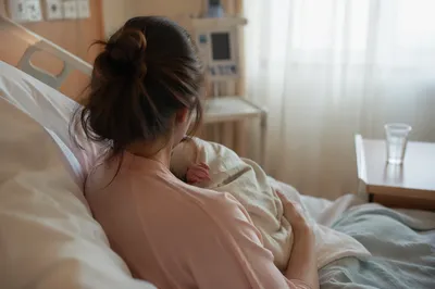 Tender Mother and Newborn in Hospital