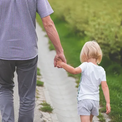 Parent and Child Walking Hand in Hand