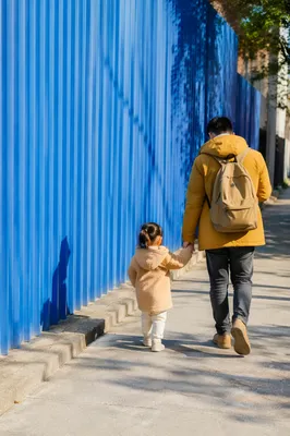 Parent and Child Walking Hand in Hand