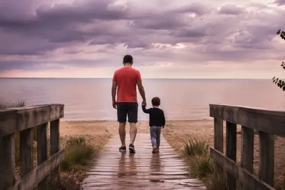 Parent and Child Walking to Beach