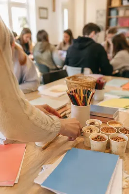 Parent Preparing Craft Table in Community Room