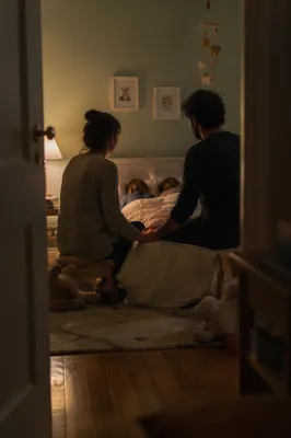 Parents Praying Over Children at Bedtime