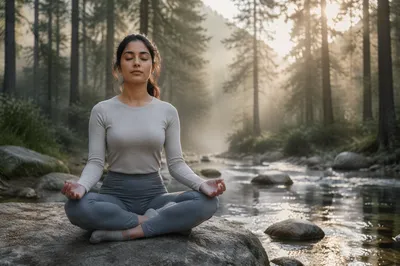 Woman Meditating Beside Forest Stream