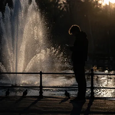 Solitary Silhouette by Sunset Fountain