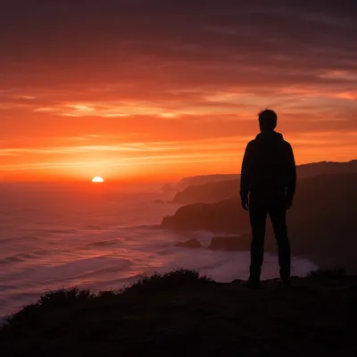 Solitary Silhouette on Coastal Bluff at Sunset