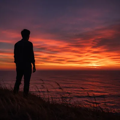 Solitary Man Silhouette on Coastal Bluff