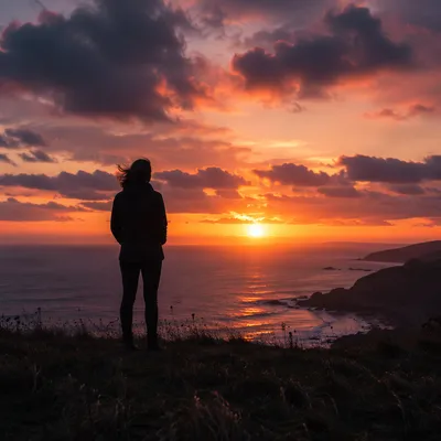 Solitary Silhouette on Coastal Bluff at Sunset