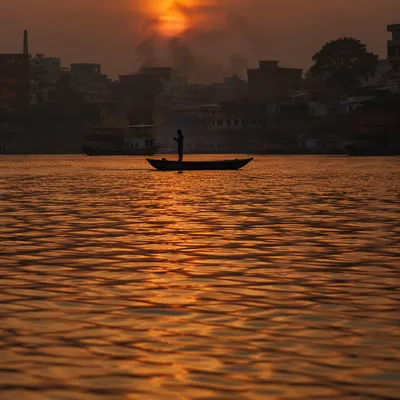 Lone Silhouette on River at Sunset