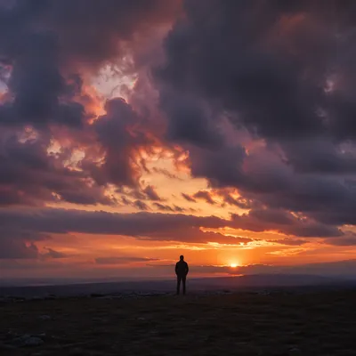 Solitary Silhouette Beneath Dramatic Sunset Sky