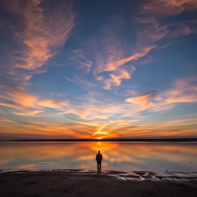 Solitary Silhouette at Dramatic Coastal Sunset