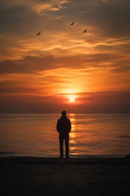 Solitary Silhouette at Dramatic Sunset Shore