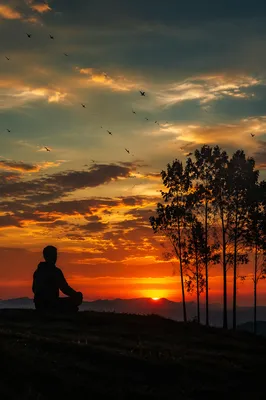 Meditating Silhouette Beneath Dramatic Sunset Sky