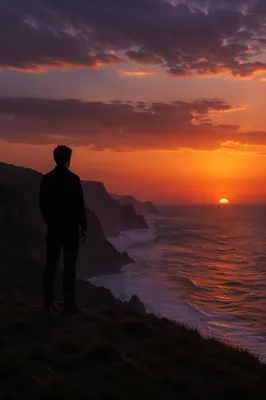 Solitary Silhouette on Coastal Bluff Sunset