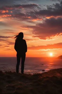 Solitary Silhouette on Coastal Bluff at Sunset