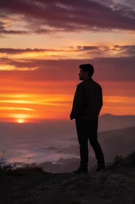 Solitary Man Silhouette on Coastal Bluff