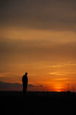Solitary Silhouette Beneath Dramatic Sunset Sky