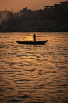 Lone Silhouette on River at Sunset