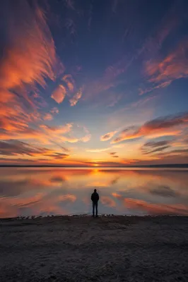 Solitary Silhouette at Dramatic Coastal Sunset