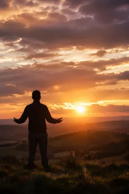 Silhouette in Prayer at Dramatic Sunset