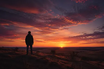 Solitary Silhouette on Hill at Sunset