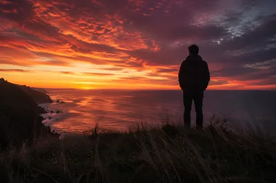 Solitary Silhouette on Coastal Bluff at Sunset