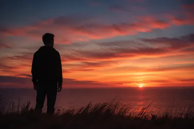 Solitary Man Silhouette on Coastal Bluff