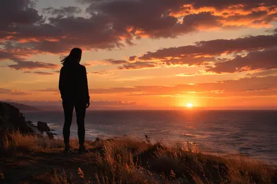 Solitary Silhouette on Coastal Bluff at Sunset