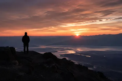 Silhouette Praying Over Sunset Mountain Valley
