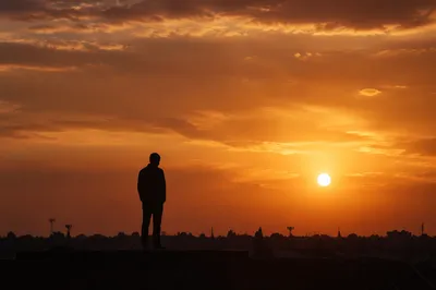 Contemplative Silhouette at Dramatic Sunset