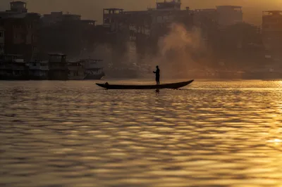 Lone Silhouette on River at Sunset