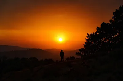 Lone Silhouette Before Dramatic Sunset