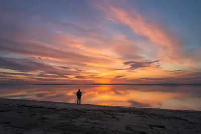 Solitary Silhouette at Dramatic Coastal Sunset