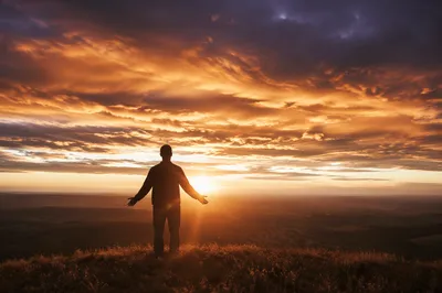 Prayerful Silhouette on Sunset Ridge